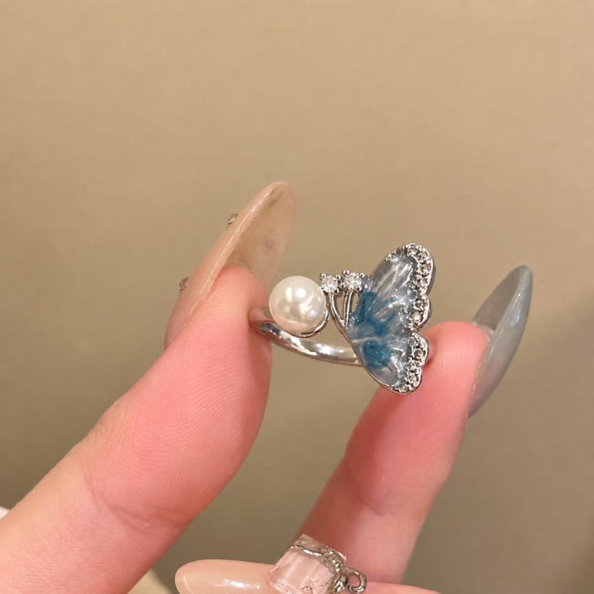 Elegant Butterfly Design with Pearl Accent — image 1